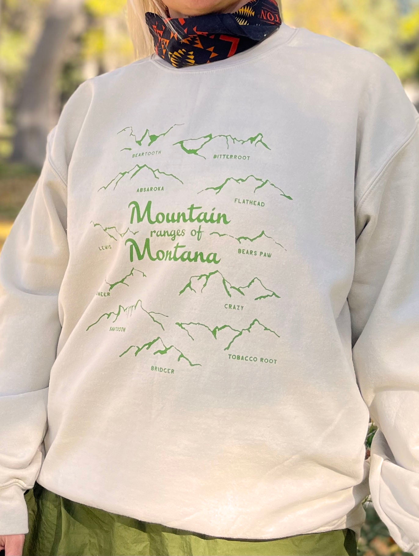 Mountain ranges of montana crew neck sweatshirt cream with green screen print bridger bozeman big sky missoula yellowstone glacier souvenir skier hiker adventure western fashion style hb elliot